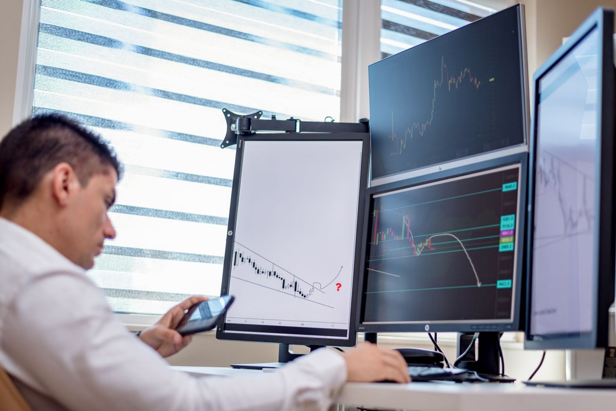 Person adjusting computer monitor for AI workflow