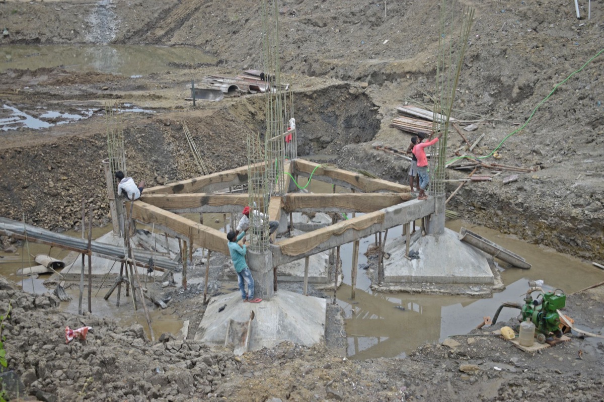 A construction site at sunset, with crew packing tools in heavy silence, highlighting the limits of a safety-only culture.